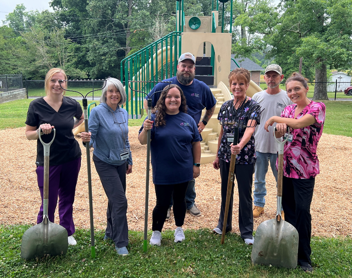 Volunteers from Piedmont Crossing in Thomasville spread mulch at The Mill playground on the Mills Home campus. Below, Odum Home director Kathy Locklear welcomes members from Crossroads Church Benson. Right, 30 servicemen from Camp Lejeune volunteered at Kennedy Home in Kinston.
