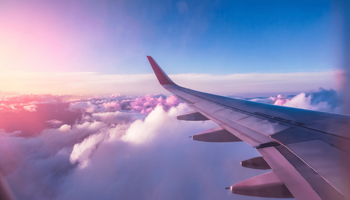Airplane taking off at sunrise, symbolizing new beginnings.