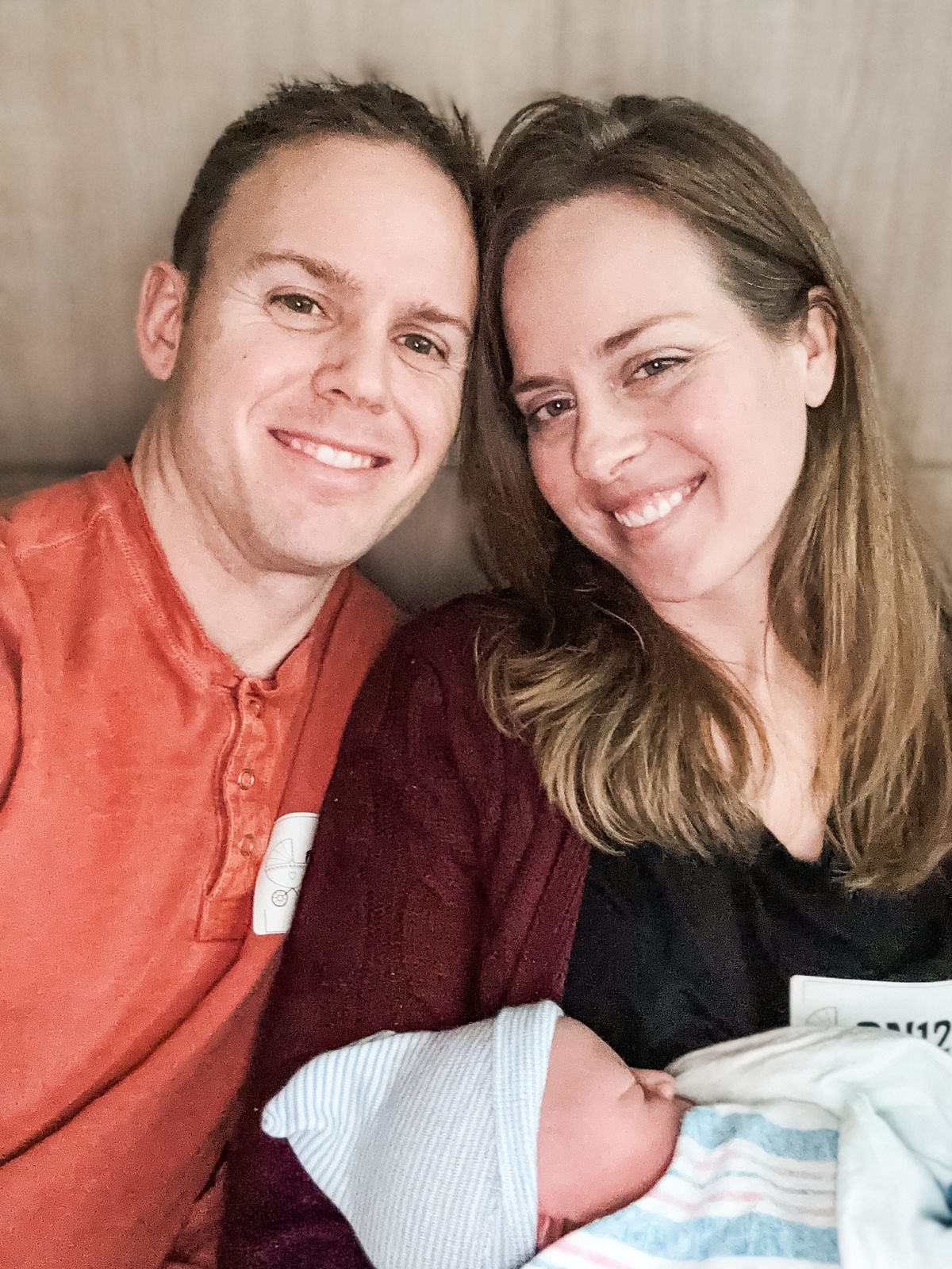 Adoptive parents holding newborn