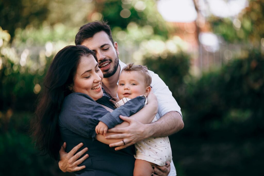 A cheerful family enjoying a joyful moment outdoors, embracing with love and happiness.