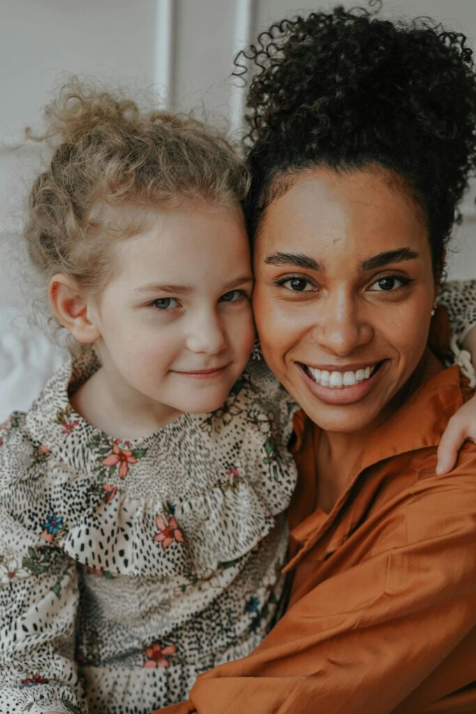 A joyful mother and daughter embrace, showcasing love and happiness.