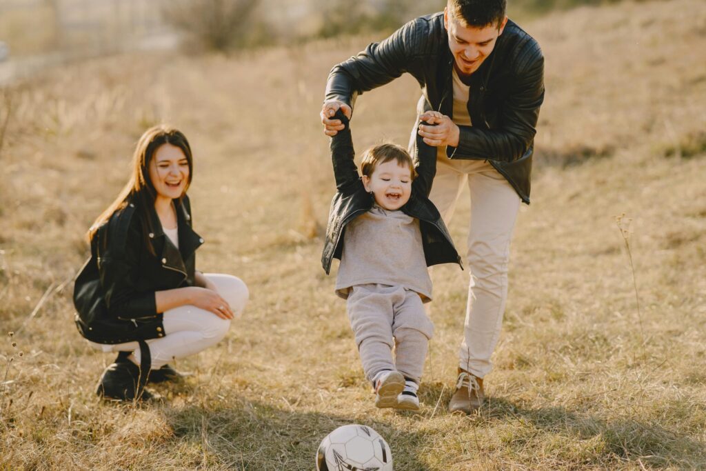 Happy family playing outdoors
