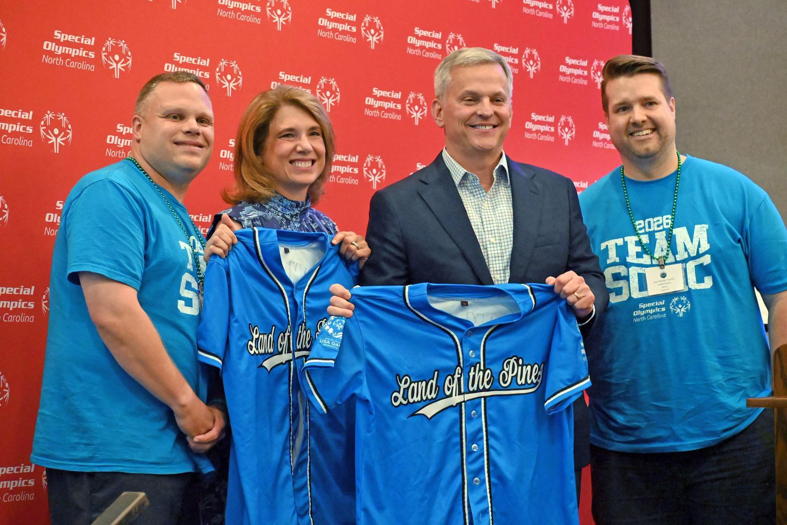 Chris Kiser and teammate Buddy Forrest meet North Carolina Governor Josh Stein and First Lady Anna Stein at a dinner.