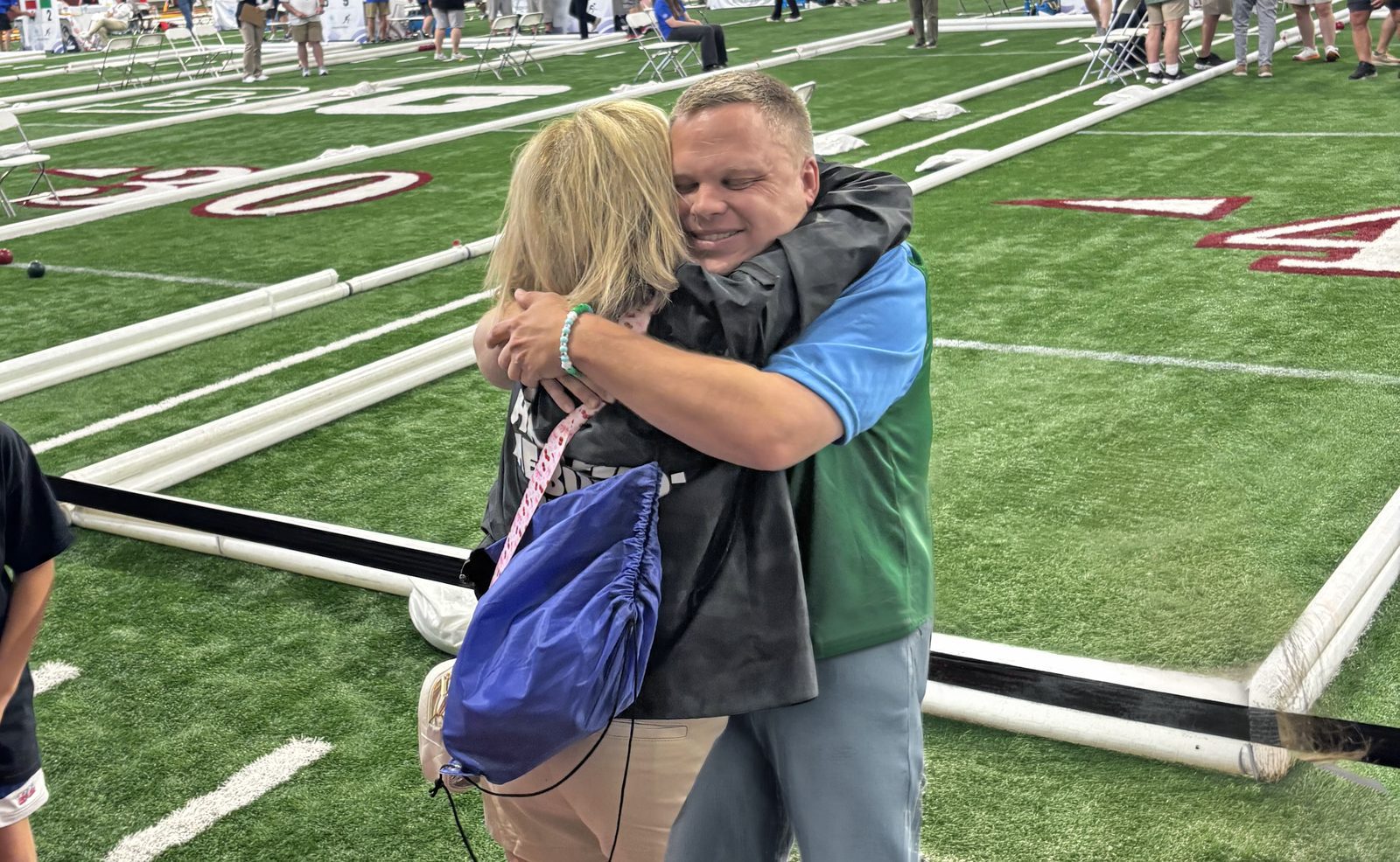 Chris Kiser's mother, Linda, embraces him on the sidelines at the Special Olympics USA Games.