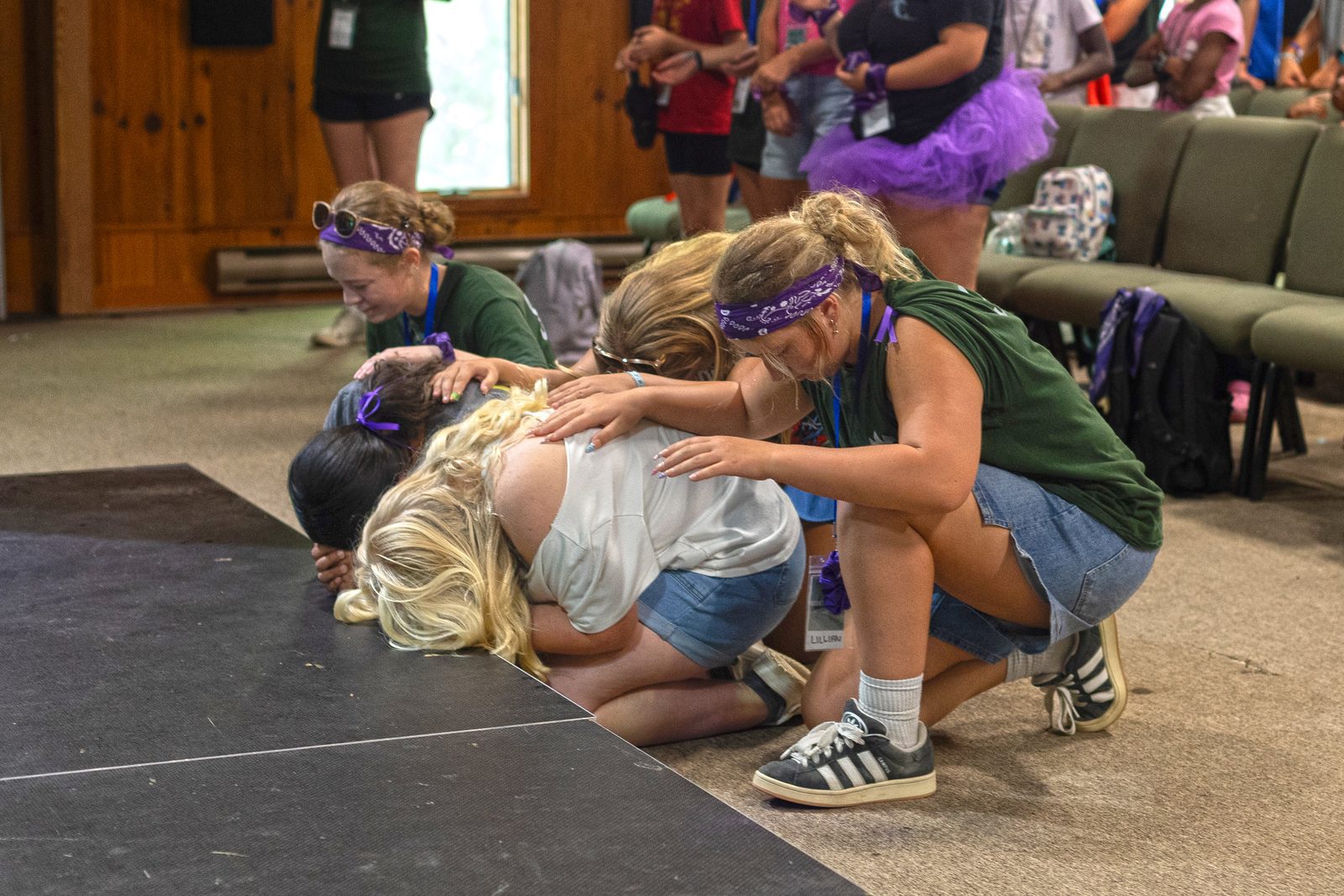 Campers and student leaders gather at the altar to pray together.