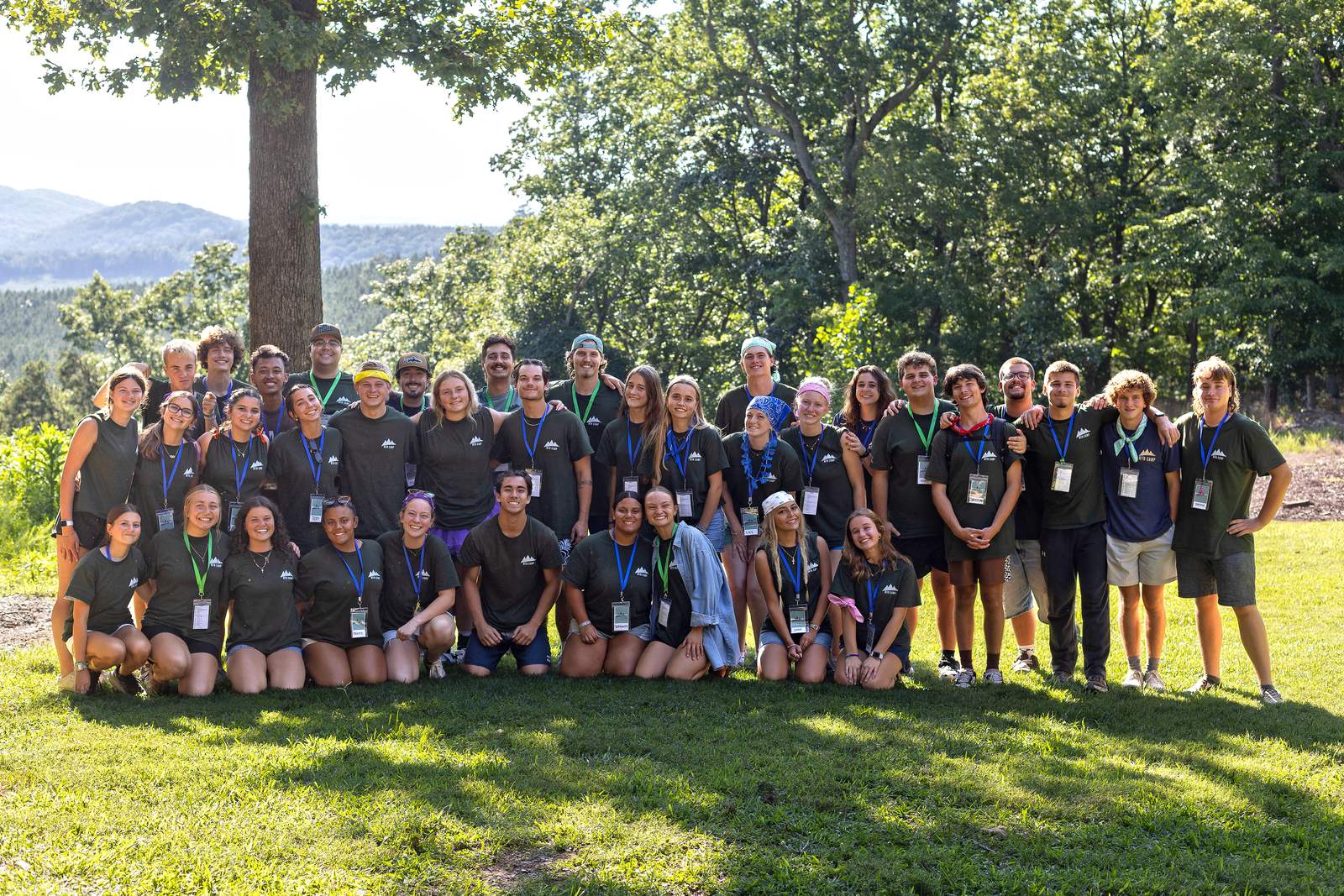 The student ministry team from Scotts Hill Baptist Church gathered outdoors for a group photo with mountains in the background.
