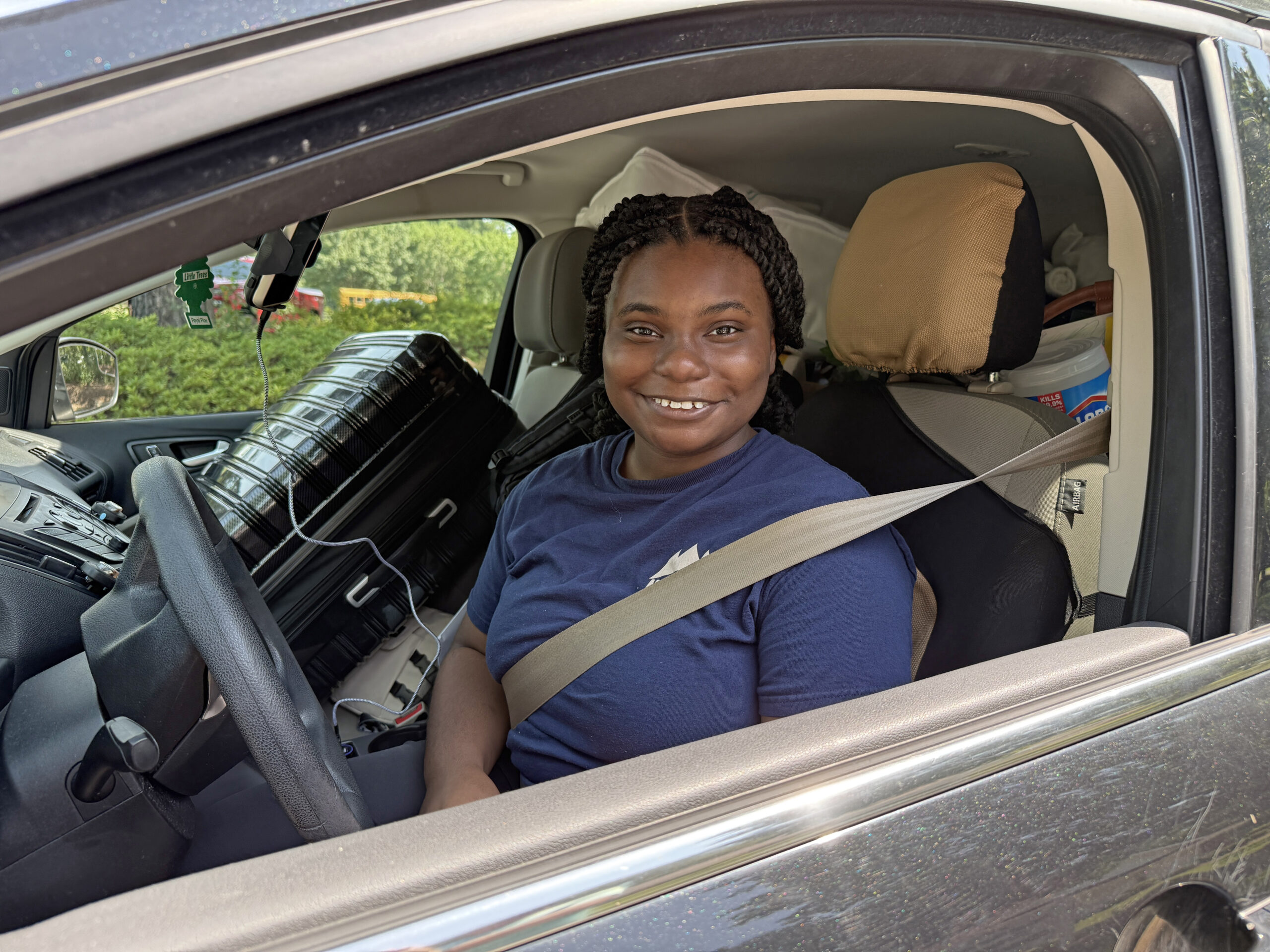 Autumn sits in her packed car.