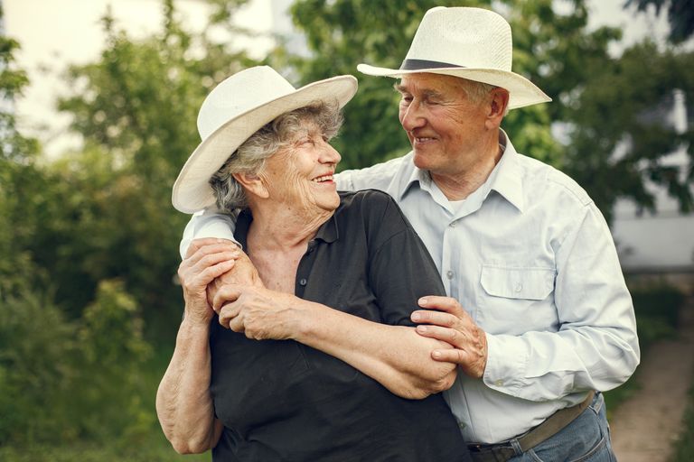 Older couple embracing outdoors, representing a lasting legacy of care for children and families.