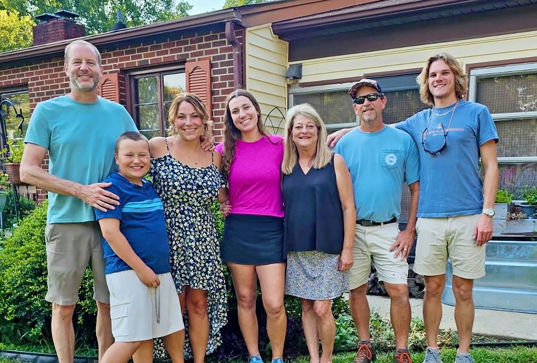 Olivia with her adoptive family and her birth mother’s family.
