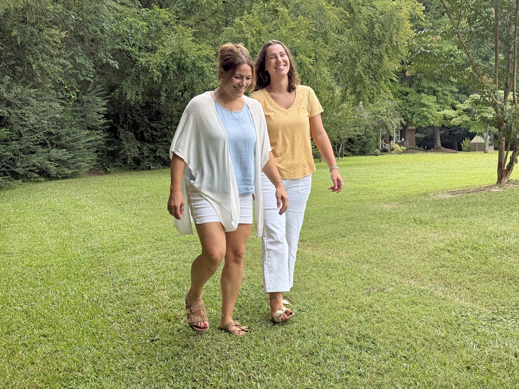 Olivia and her birth mother Noelle walking outdoors.