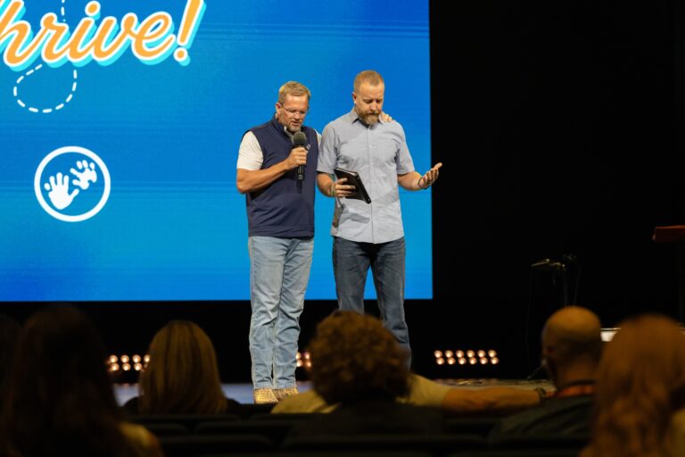 BCH CEO David Melber prays with Mercy Hill lead pastor Andrew Hopper at Thrive.