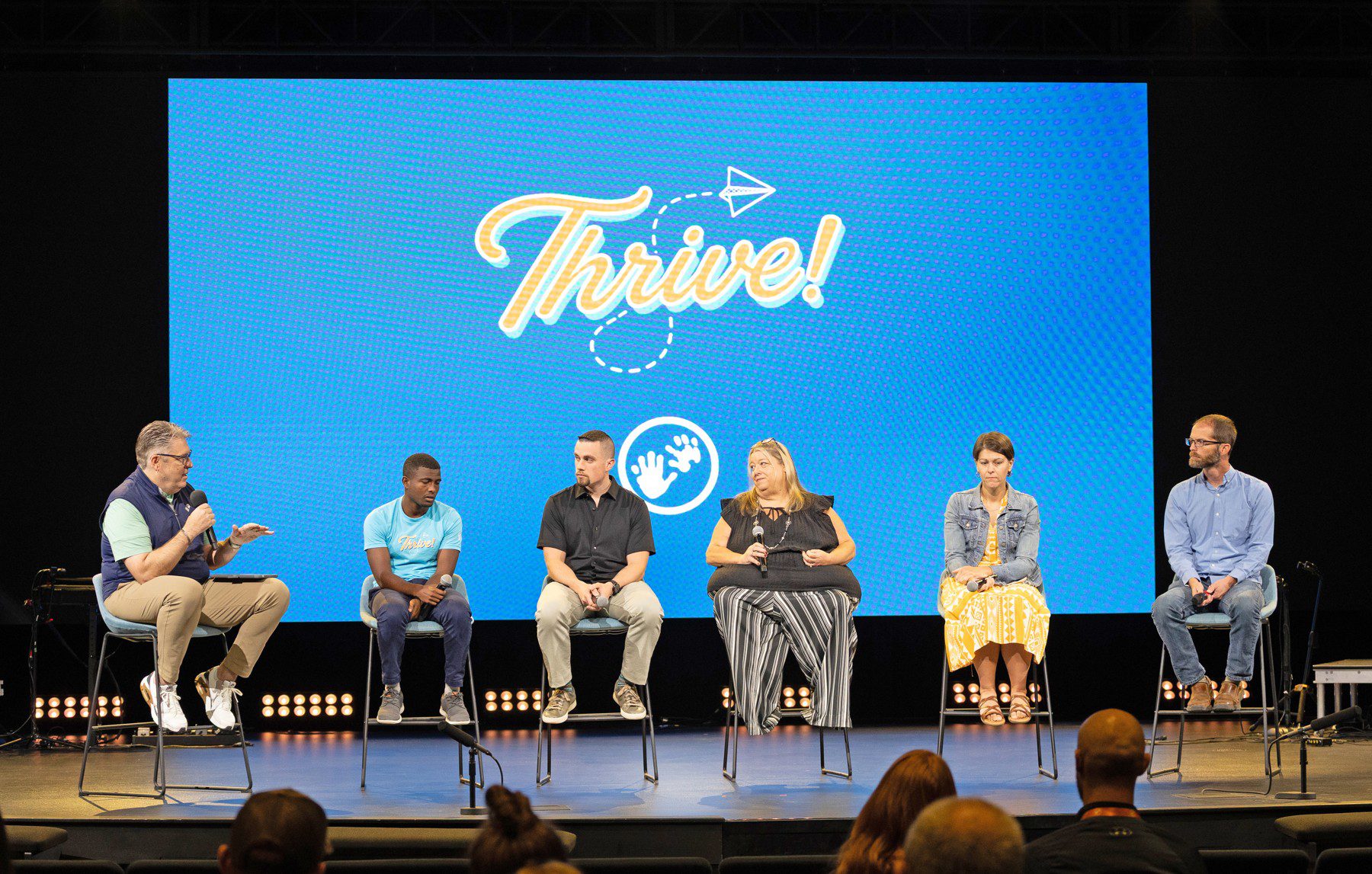 Speakers discuss fostering and adoption on the Thrive conference stage.
