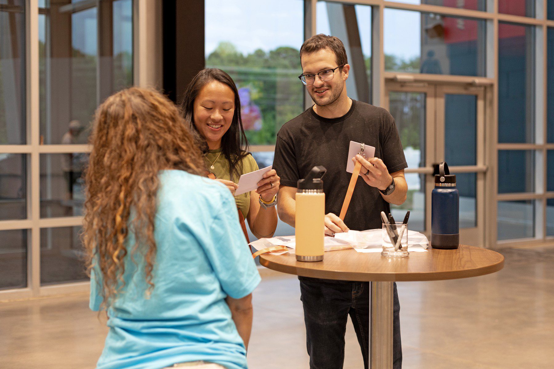 Attendees are welcomed at a Thrive check-in table.