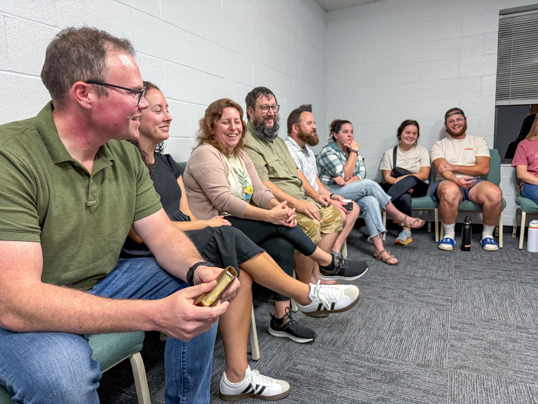 Members of the Rich Fork foster care support group laughing together during a Wednesday night meeting